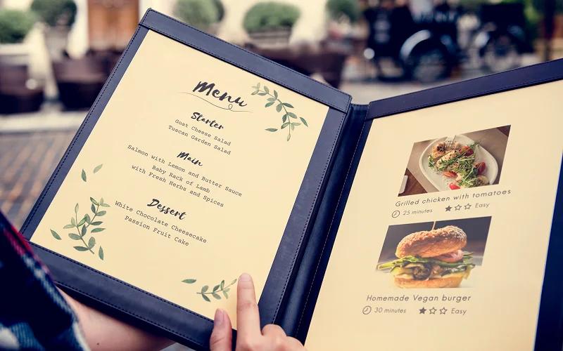 Open printed restaurant menu with food photos
